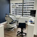 Examination room with dental chair and equipment.