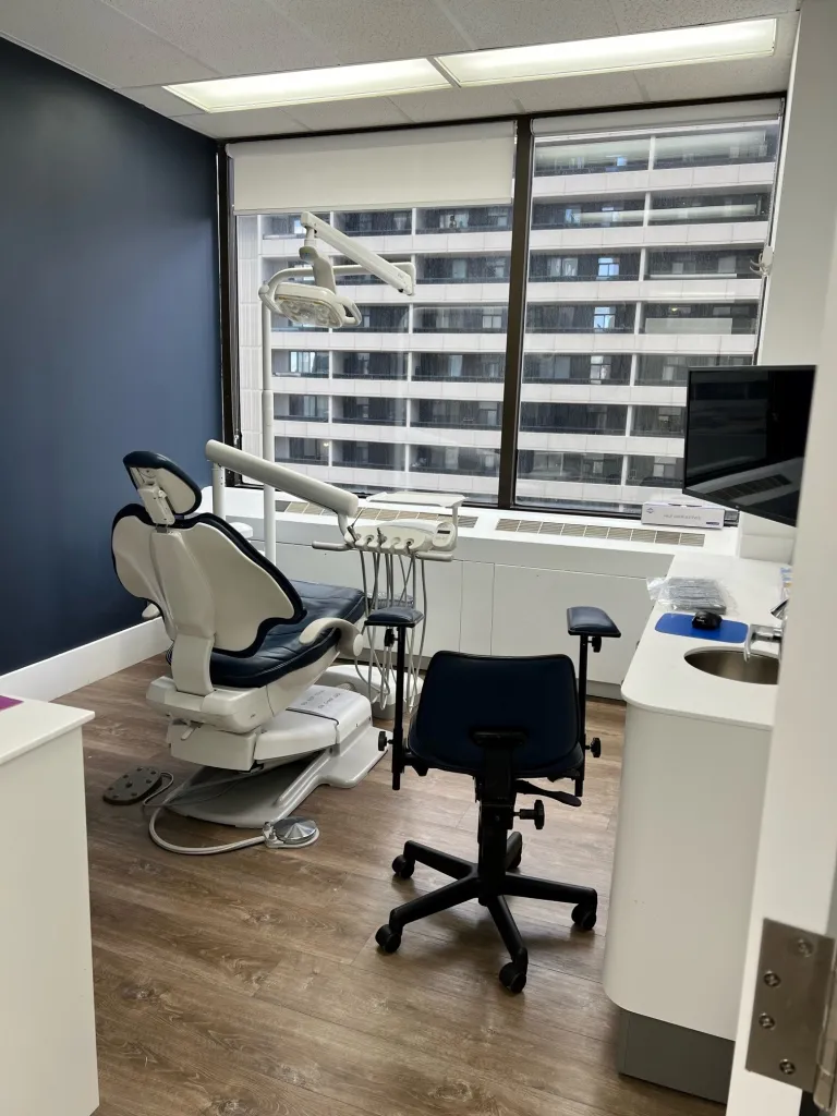 Examination room with dental chair and equipment.
