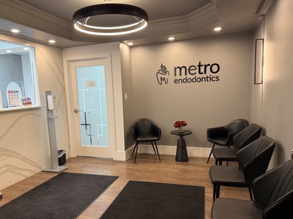 A photo of the waiting room in the Toronto office with black chairs and the Metro Endodontics signage.