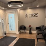 A photo of the waiting room in the Toronto office with black chairs and the Metro Endodontics signage.